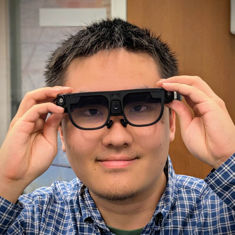 Xu Cao trying on AR smart glasses